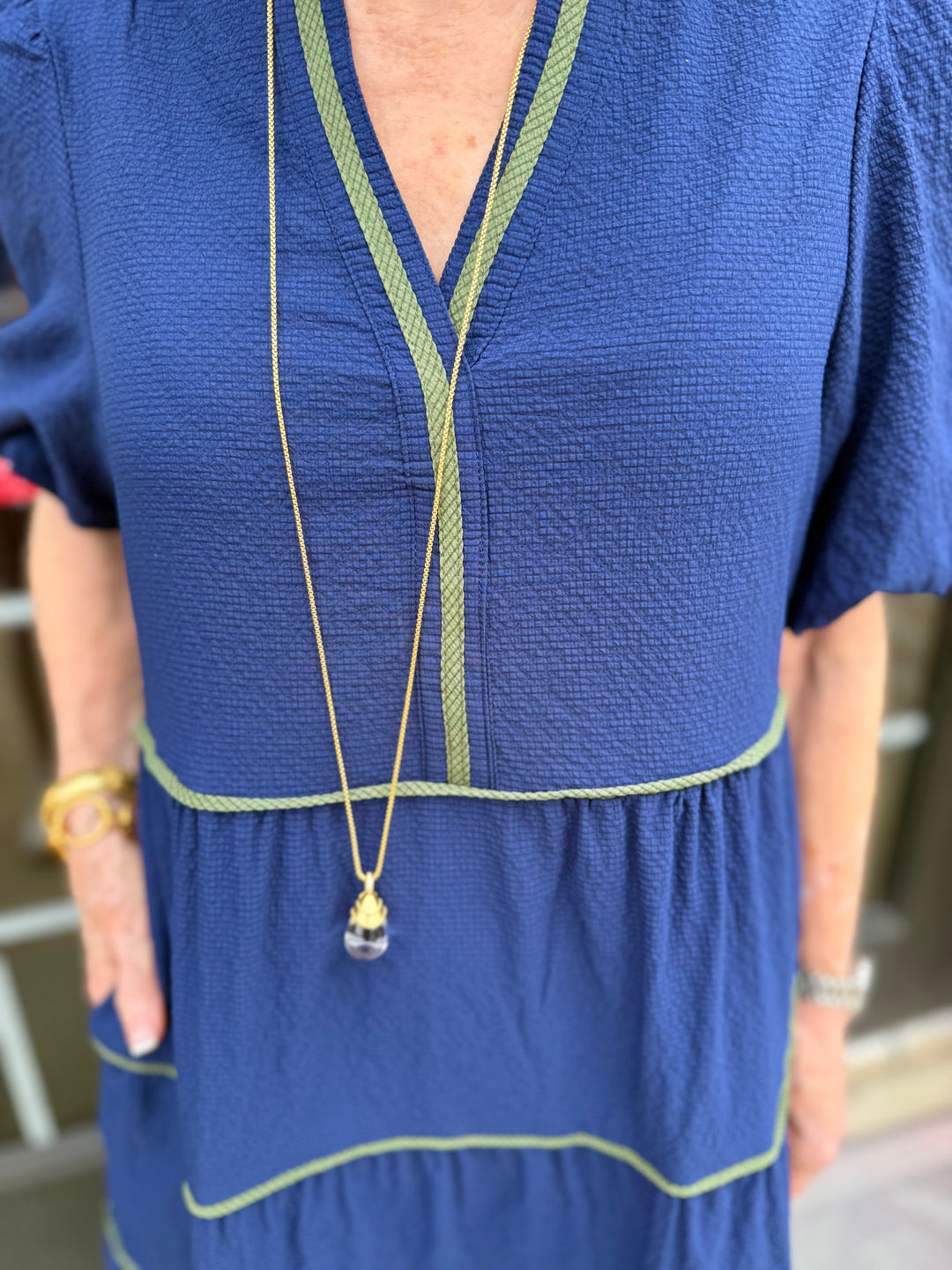 Kinsley Navy Seersucker Dress with green trim, midi length. Available in sizes XS–XL.