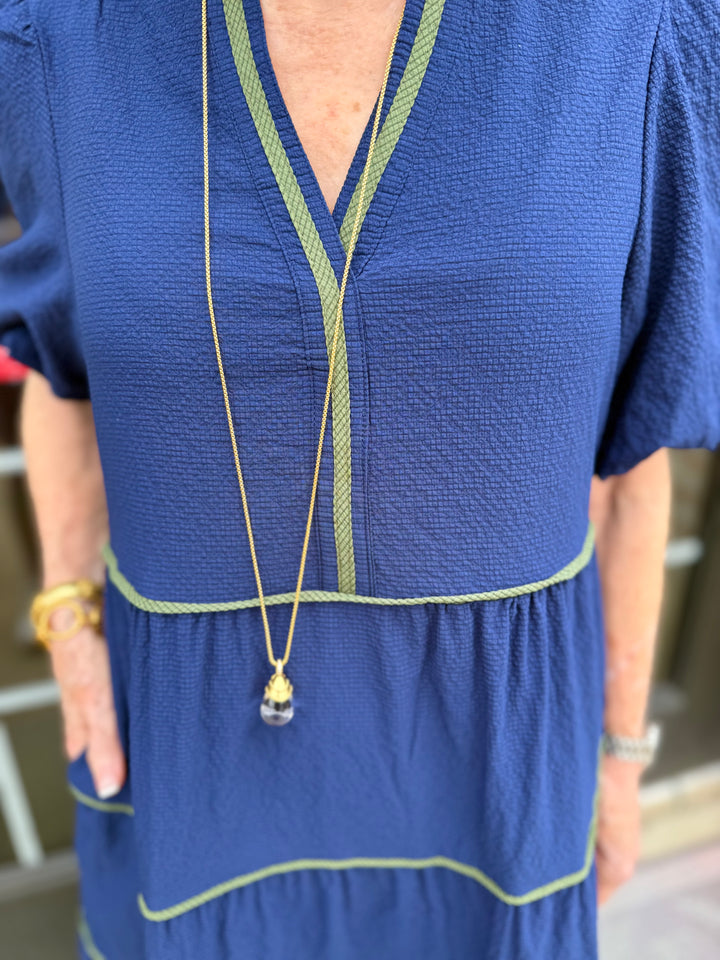 Kinsley Navy Seersucker Dress with green trim, midi length. Available in sizes XS–XL.