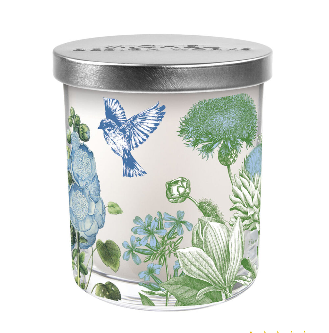 Cotton & Linen Jar Candle: Glass jar with a silver lid, detailed with botanical blue and green flowers and a blue bird. Made from premium soy blend, it emits the scent of clean cotton and fresh air. Available sizes: 8 oz, 16 oz.