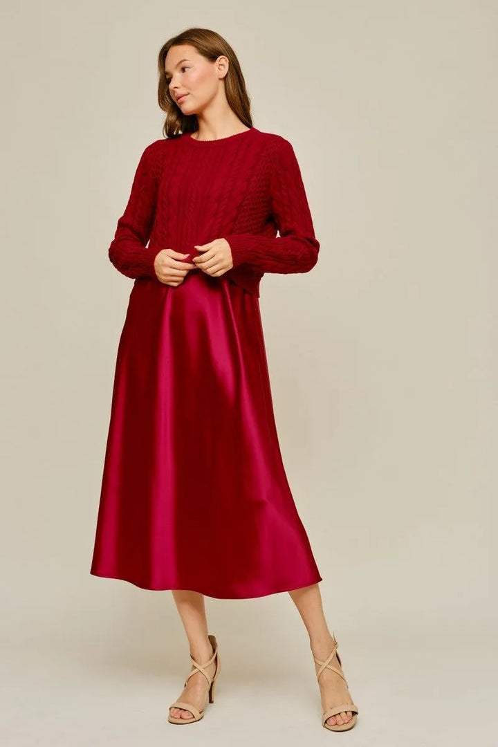 Deep red cable-knit sweater and satin midi dress set.