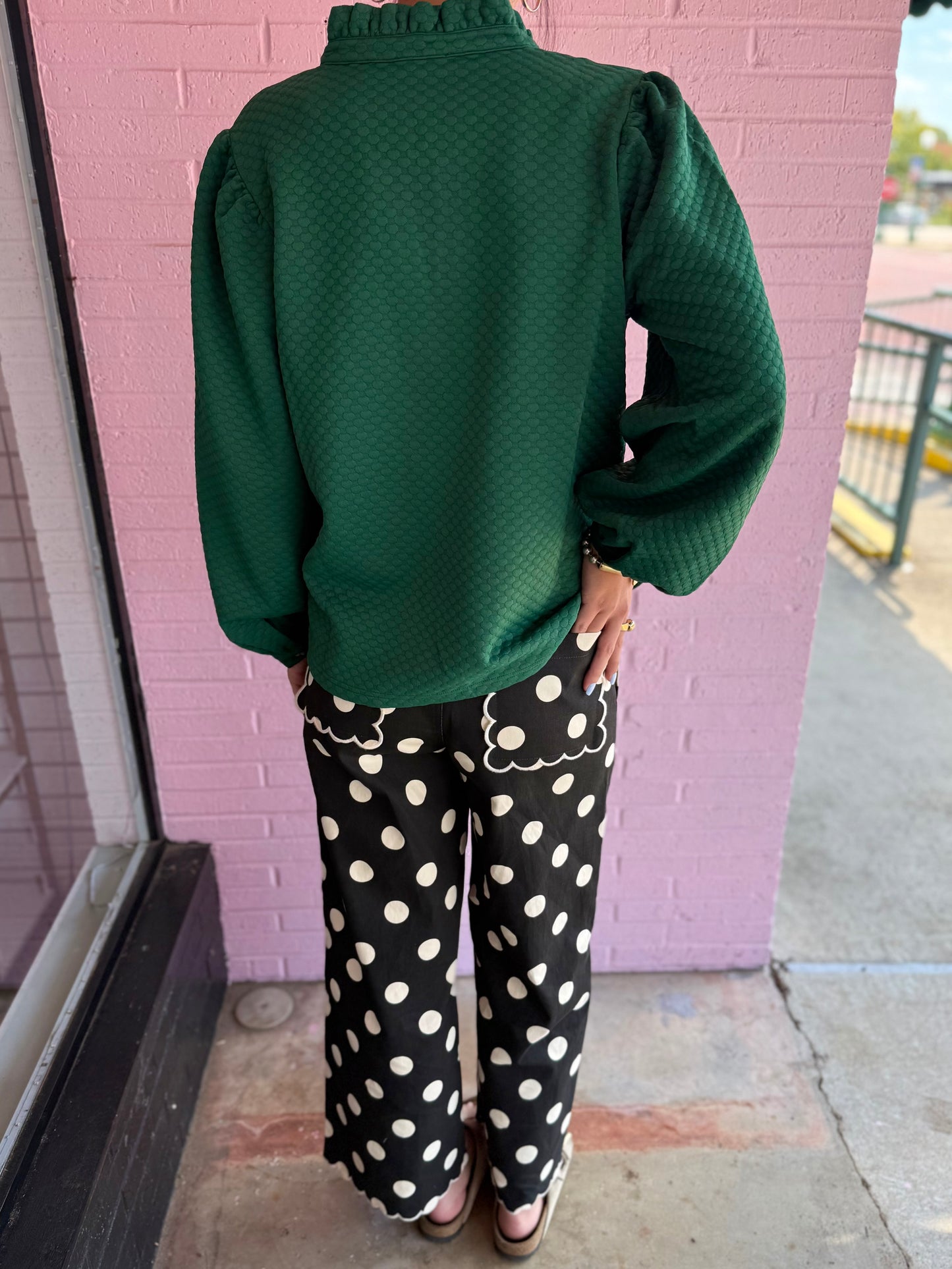 Black jeans with large white polka dots and scalloped pocket edges. Available in sizes 24–32.
