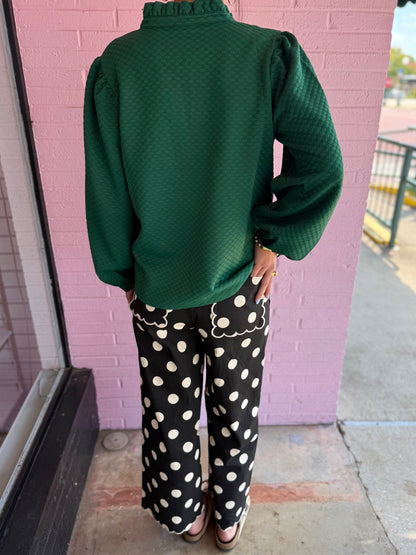 Black jeans with large white polka dots and scalloped pocket edges. Available in sizes 24–32.