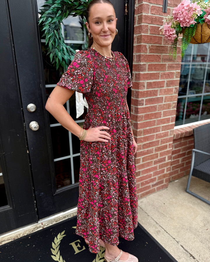 Lucille Granada Glen Cocoa Dress: dark floral print with pink and red flowers, smocked bodice. Available in sizes XS-XL.