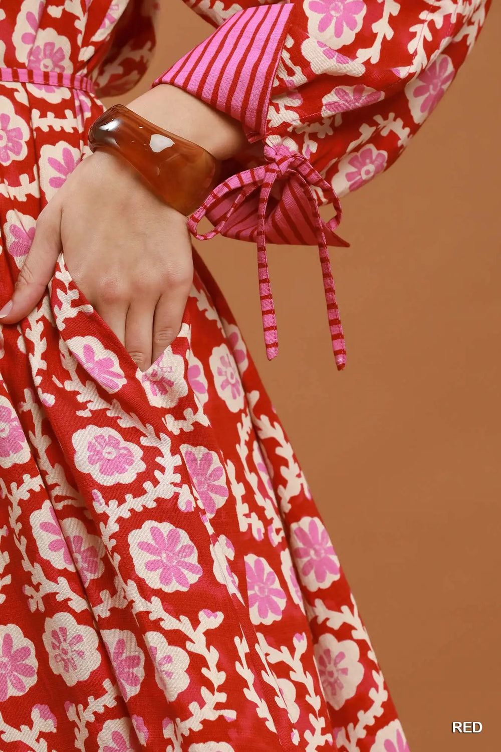 Red and pink floral midi dress with collar, tiered tie-closure sleeves, and side pockets. Available in multiple sizes.