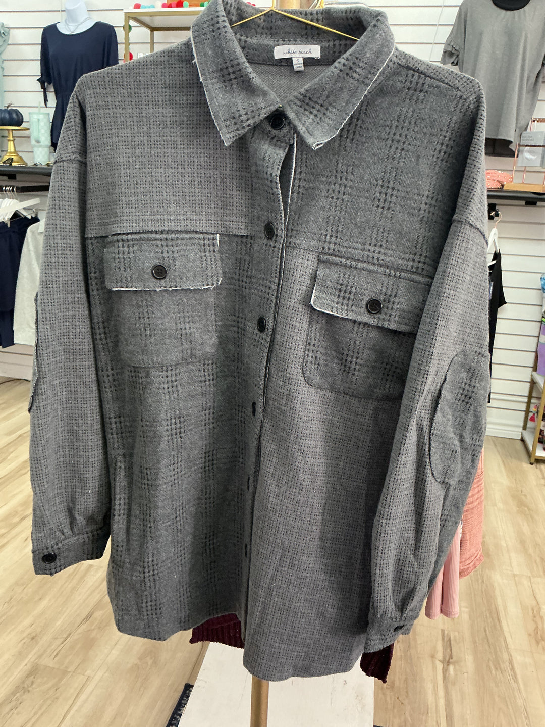 Dark grey button-up jacket with subtle checkered pattern, two chest pockets. Available in sizes S, M, L, XL.