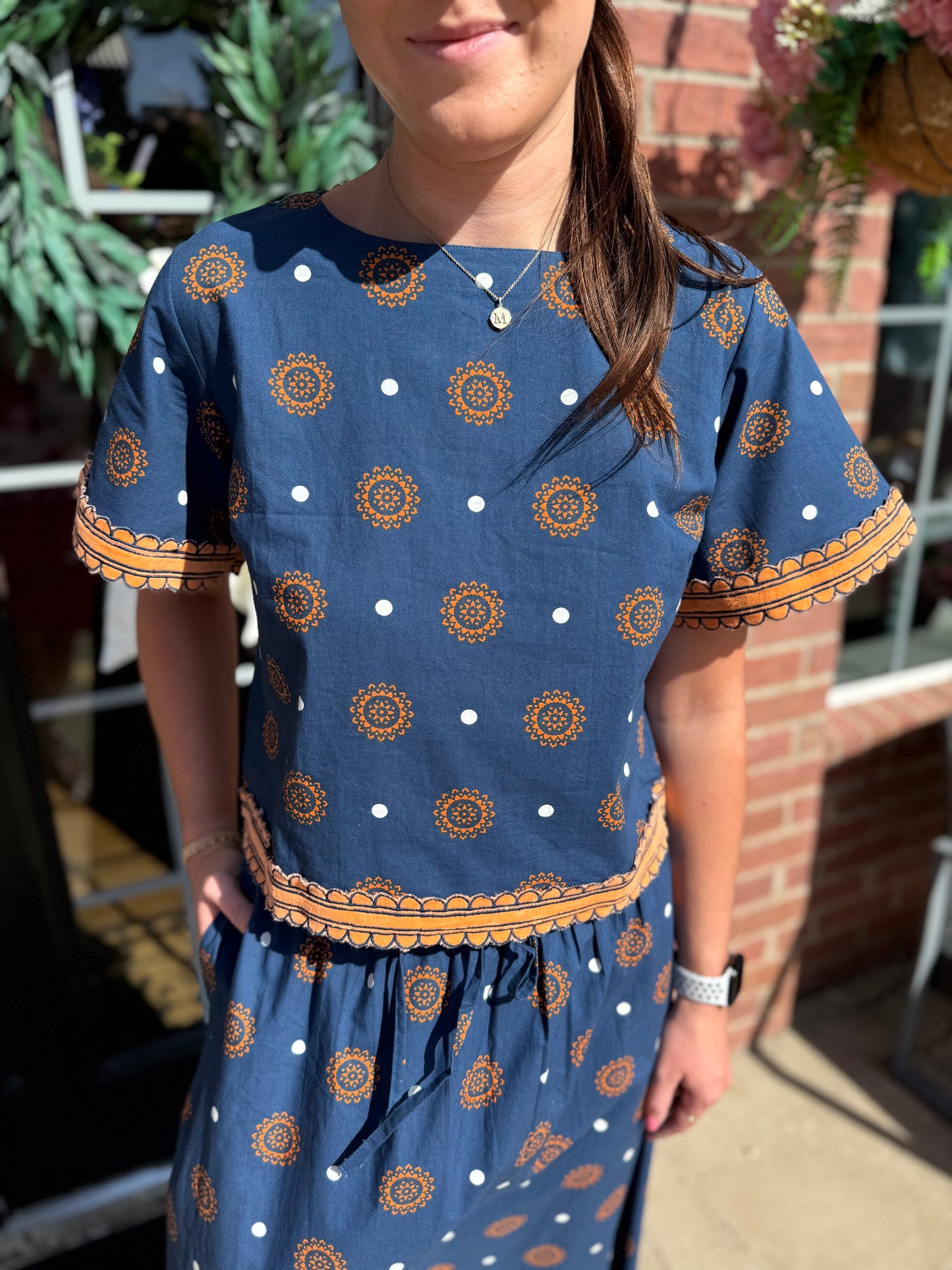 Auburn Medallion Skirt Set: two-piece blue ensemble with bold orange and white medallion patterns. Available in sizes XS–XL.