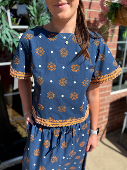 Auburn Medallion Skirt Set: two-piece blue ensemble with bold orange and white medallion patterns. Available in sizes XS–XL.