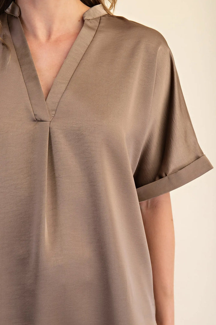 Mocha Signature Satin Top with center pleat, rolled and short cuff sleeves. Available in sizes XS-XL.