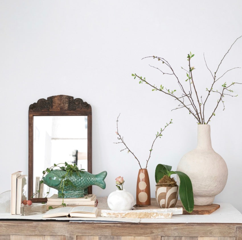 The Turquoise Fish Planter, available in small and large sizes, features a glossy blue finish and playful fish shape.