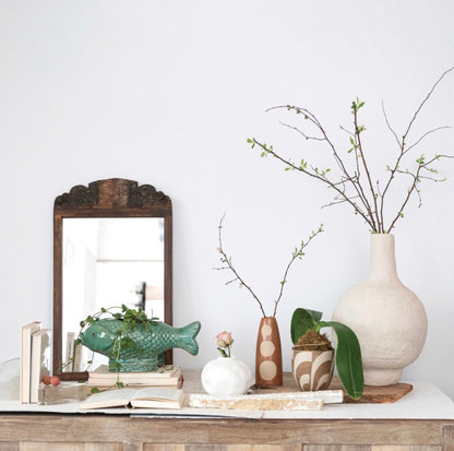 The Turquoise Fish Planter, available in small and large sizes, features a glossy blue finish and playful fish shape.
