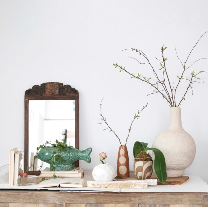 The Turquoise Fish Planter, available in small and large sizes, features a glossy blue finish and playful fish shape.