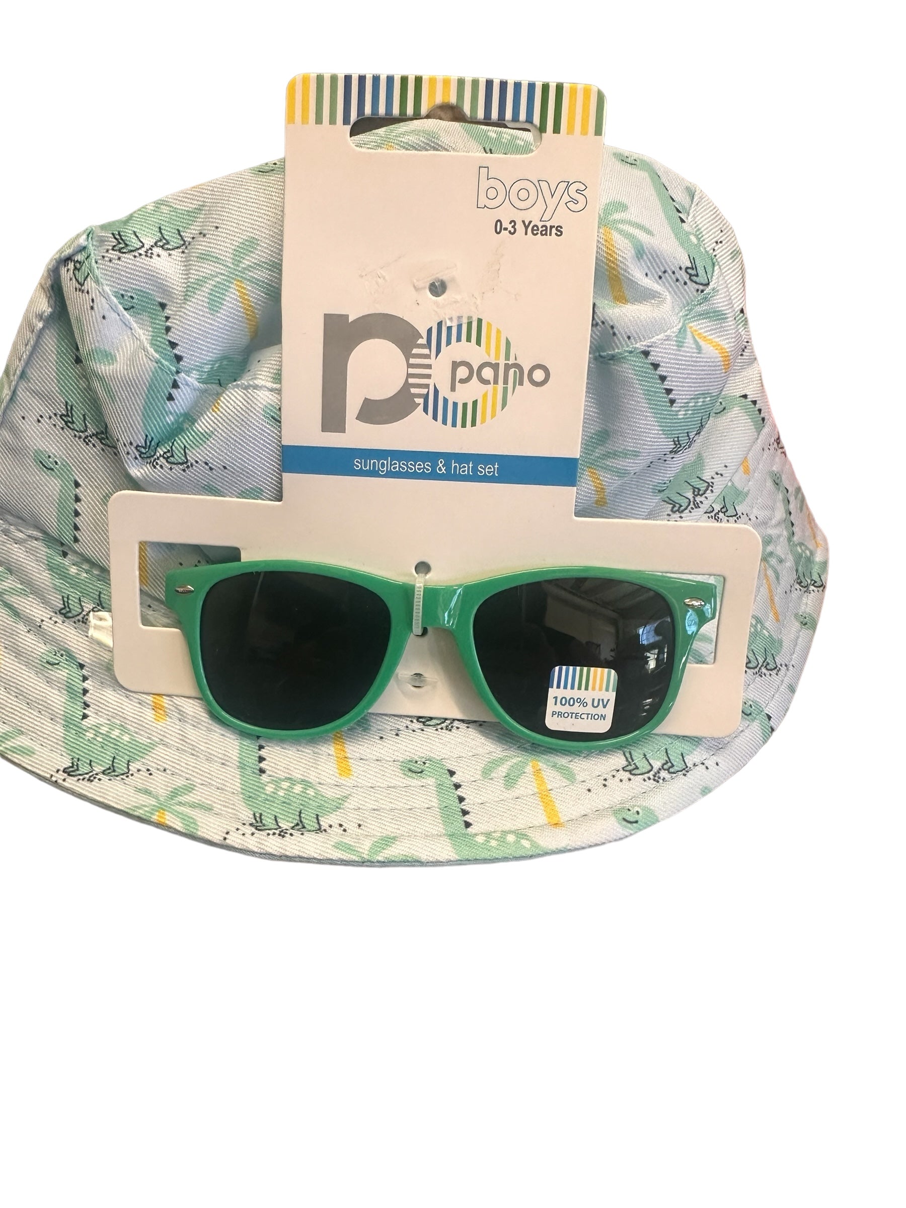 Baby boy's hat and sunglasses set for ages 0-3 years. Hat: light green with dinosaur pattern. Sunglasses: green-rimmed, UV400 protection. Packaged together. Sizes available: One size fits most (0-3 years).