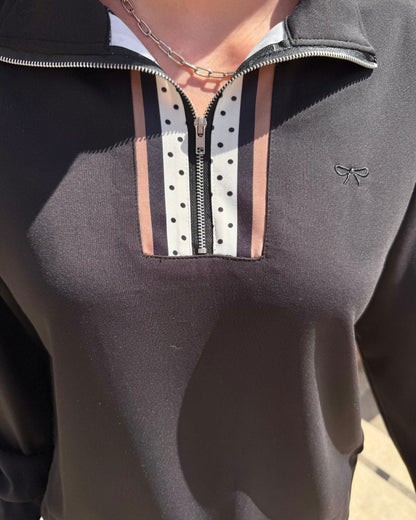 Margot Polka Dot Striped Quarter Zip features white and brown stripes with black polka dots and a small bow logo on the left. Available in sizes XS–XL.