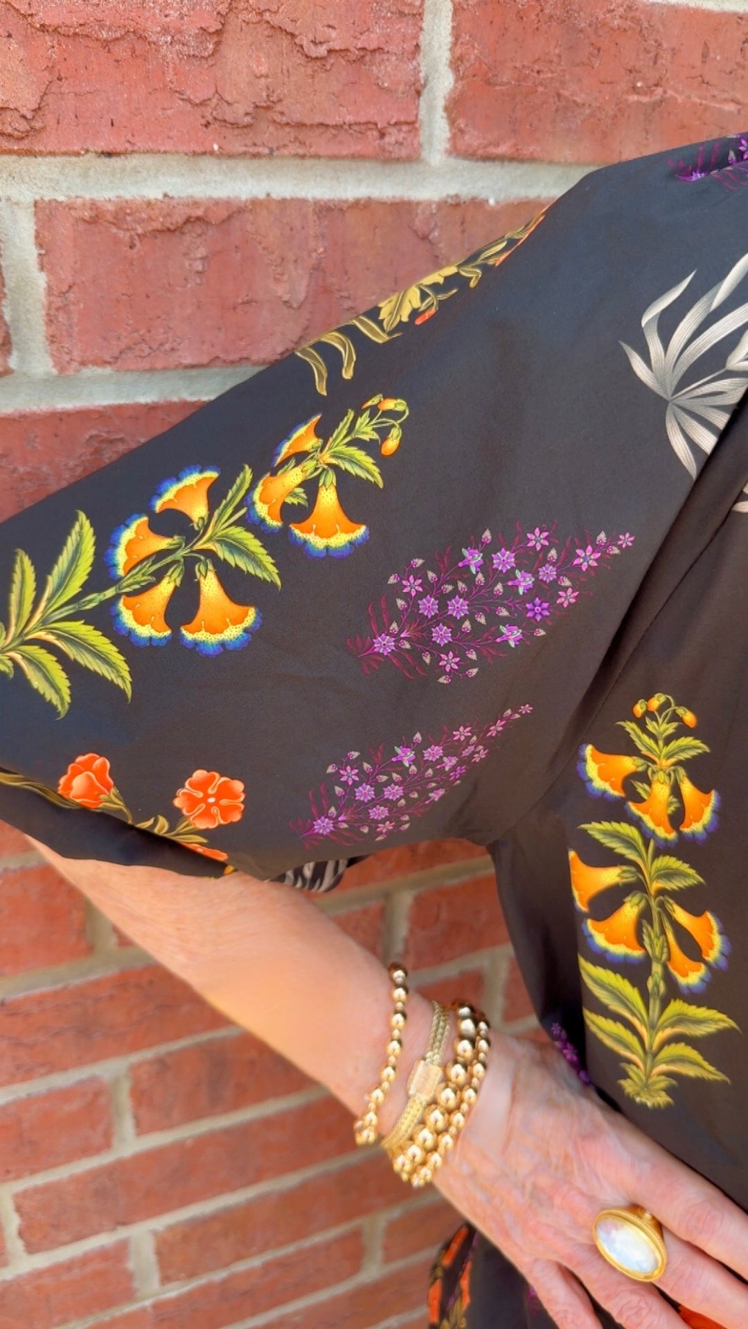 Maisie Floral Scallop Top: black blouse with delicate floral pattern and scalloped V-neckline. Available in sizes XS–XL.