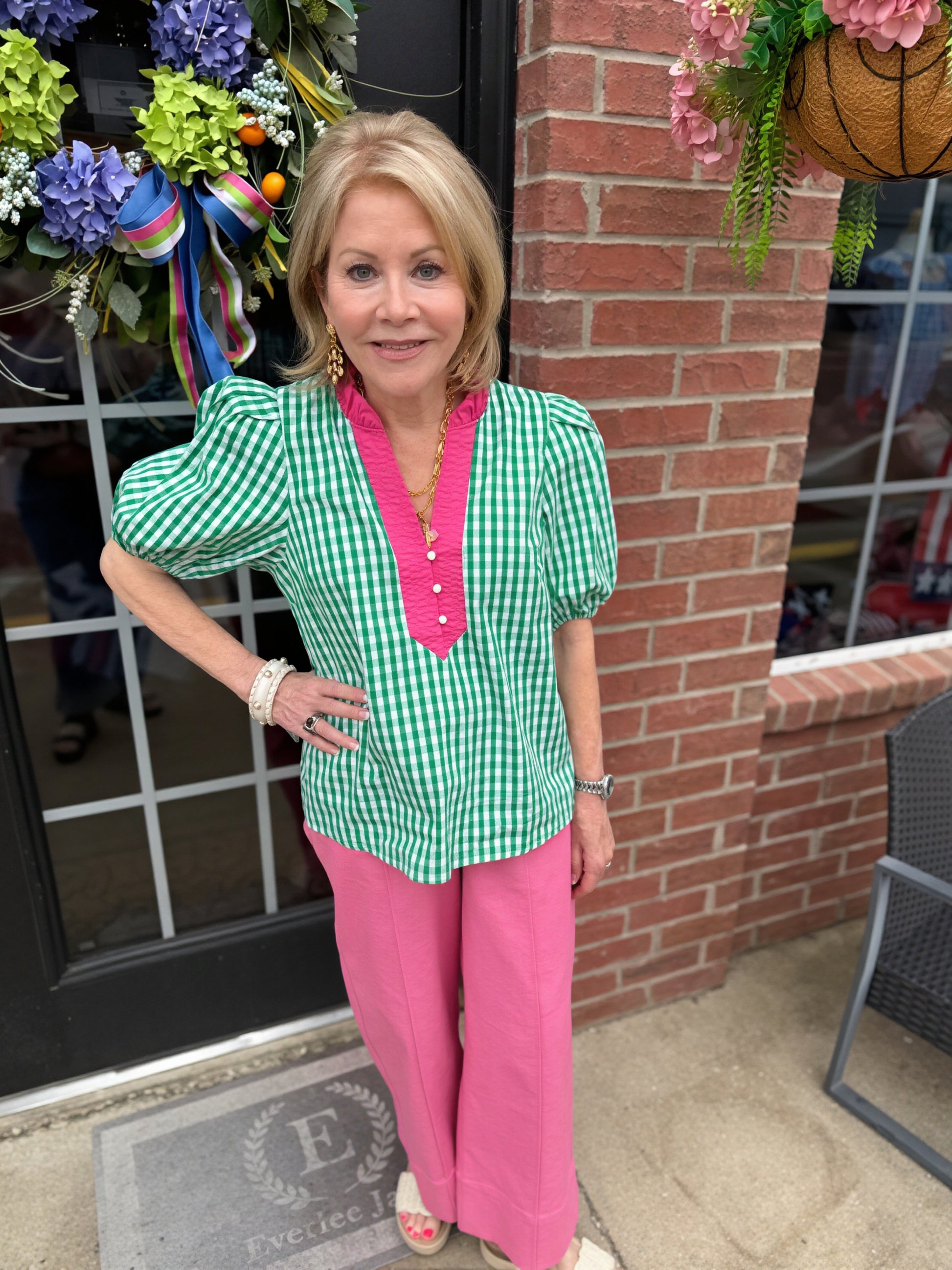 Green and white gingham puff sleeve cotton blouse with pink trim, ruffled collar. Available in sizes XS-XL.