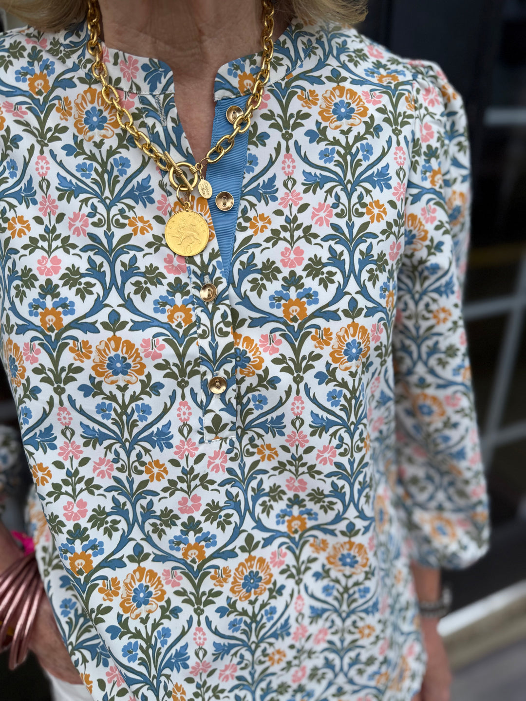 Riley Ashdown Abbey Top: balloon sleeves, blue/orange/pink floral print, gold button accents. Available in XS-XL.