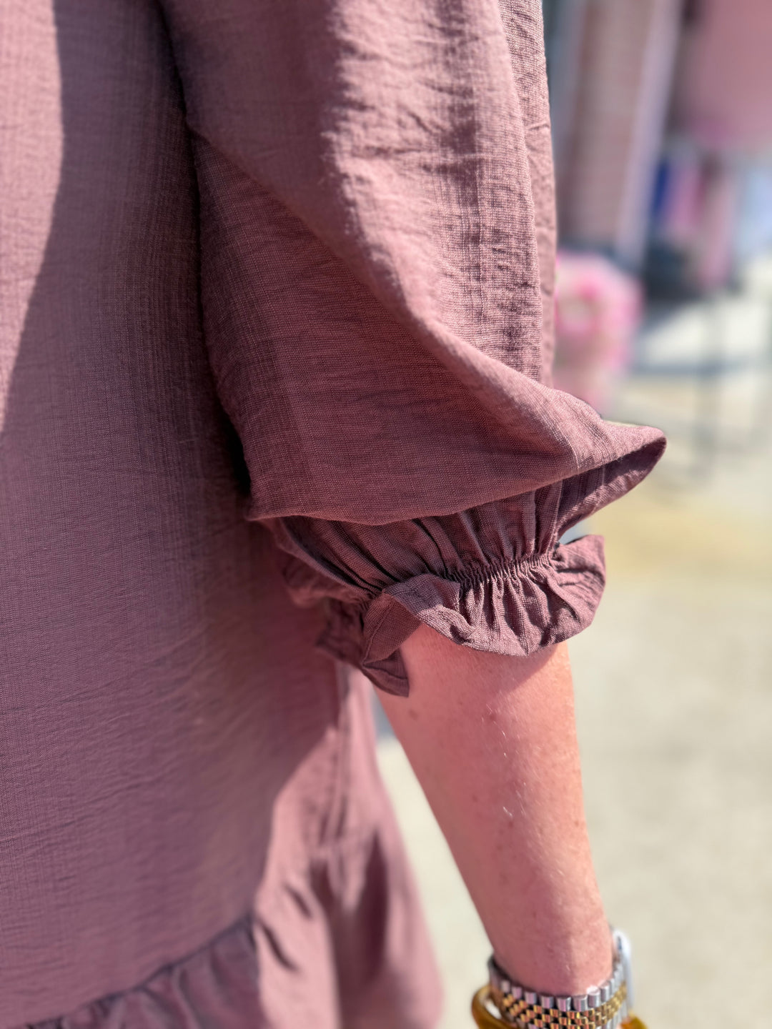 Smocked Ruffle Tiered Mini Dress in mauve with gathered sleeves. Available in sizes XS–XL.