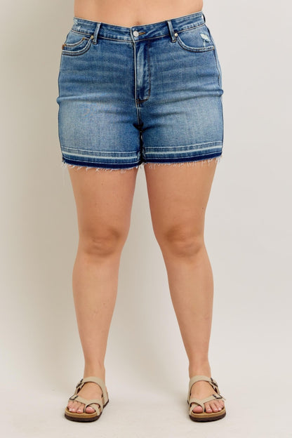 Judy Blue MR Tummy Control Vintage Wash Shorts with frayed hem, faded stripe above hem. Sizes: S-XL.
