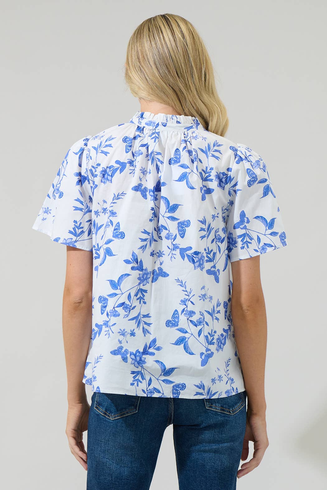 Leya Floral Inaya Split Neck Top with blue, white, and butterfly patterns. Available in sizes XS–XL.