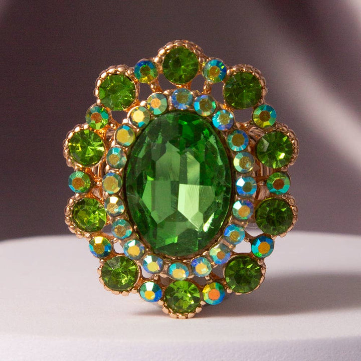 Oval Crystal Sunburst Double Halo Stretch Ring with large green center stone, smaller green and blue-green crystals. Sizes adjustable.