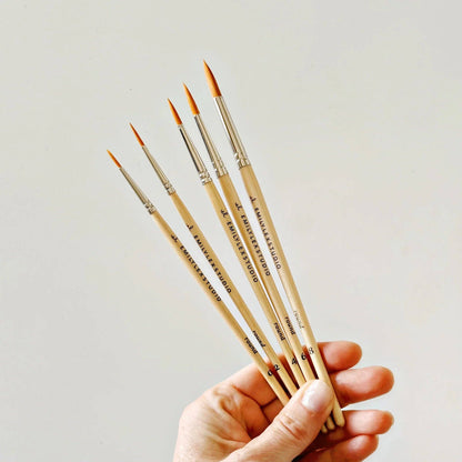 Watercolor Paintbrush Set: five wood-handled, fine-tipped round brushes in sizes including round 2 and round 4.