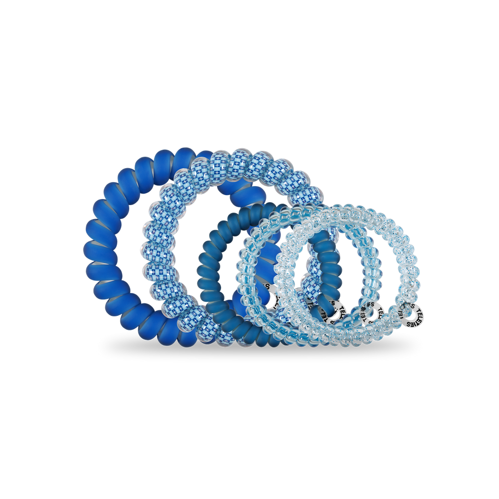 Four blue Hanukkah-inspired spiral hair coils in assorted sizes, worn as hair ties or bracelets. Sizes: small to large.