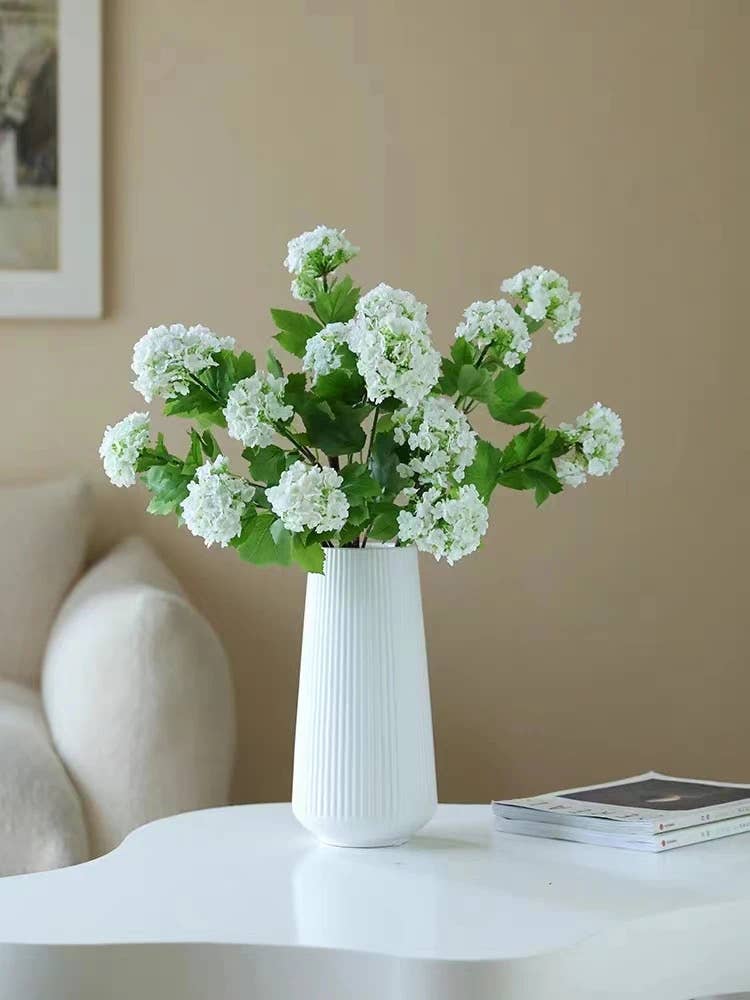 White ceramic vase with 40" long, 5 blooms of premium faux Snowball hydrangea spray in green. Available sizes: Single size item.