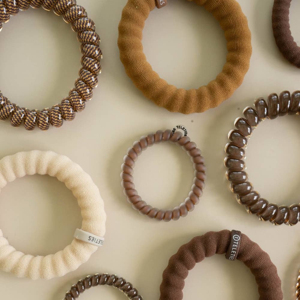 Morning Brew Small Hair Ties in brown, beige, and cream, with spiral coil options; feature no-crease and waterproof designs; available in small size.
