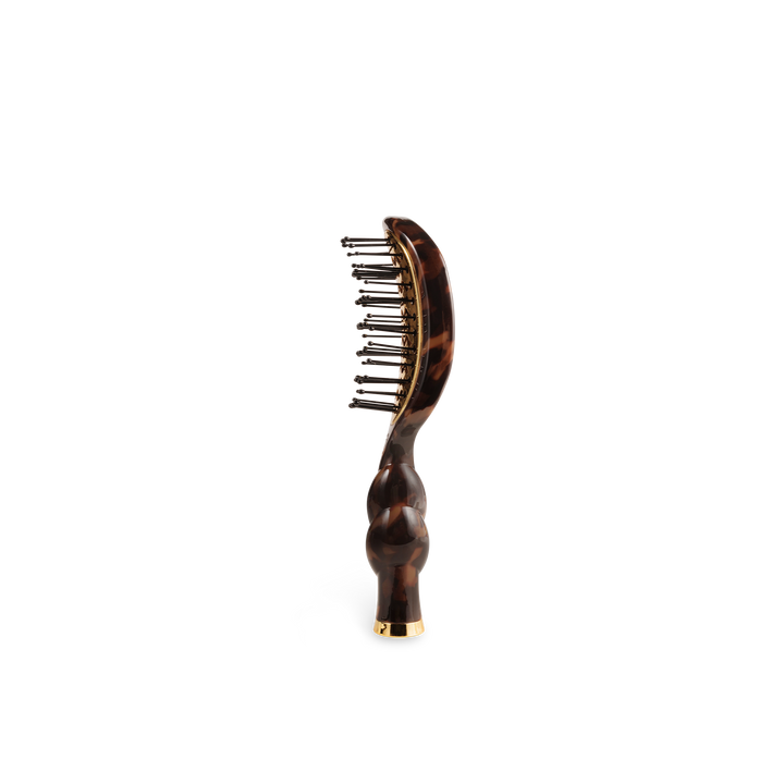 The Mini Vented Brush | Tortoise has a curved handle, metal bristles, and is available in mini size.