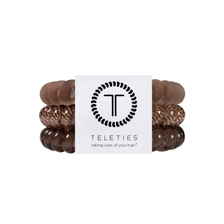 Set of five large Morning Brew Hair Ties in brown and patterned colors, with a white label showing the TELETIES logo and tagline, available in large size. No-crease design for all-day hold.