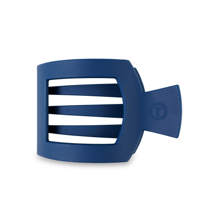 The TELETIES Square Flat Hair Clip is a blue plastic clip with a rectangular design, three horizontal bars, and a strong flat grip. Sizes available: Small and Large.