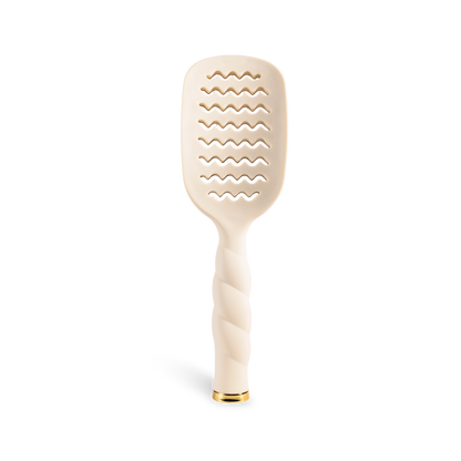 The Vented Hair Brush | Tan features a twisted handle, gold-accented base, and wavy openings on a beige brush head. Available in multiple sizes.