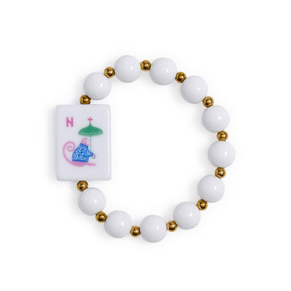 Mahjong Beaded Stretch Bracelet with alternating white and gold beads, a rectangular tile featuring a blue and pink monkey holding a green umbrella next to the red letter “N,” and vibrant acrylic accents. Available in multiple sizes.
