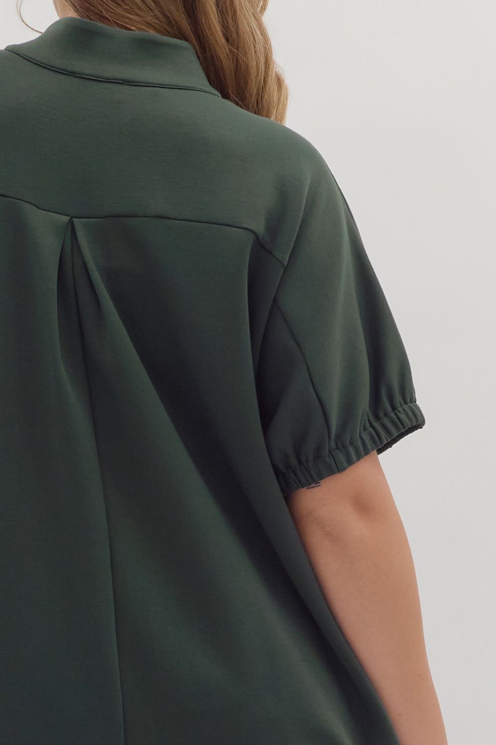 Dark green Collie Midi Dress with V-neck, band collar, short sleeves, elasticated cuffs, and pleated back. Available in multiple sizes.