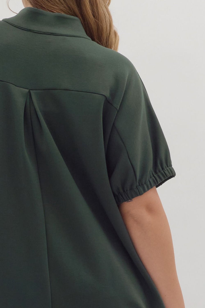 Dark green Collie Midi Dress with V-neck, band collar, short sleeves, elasticated cuffs, and pleated back. Available in multiple sizes.