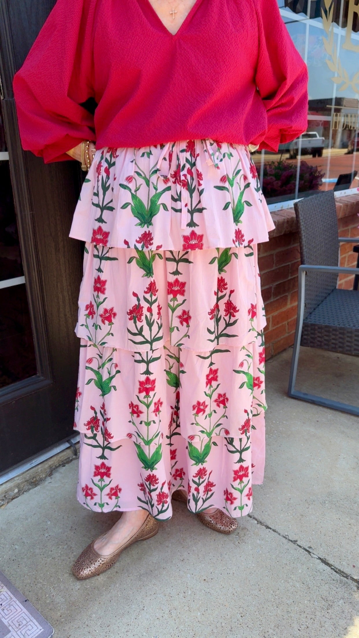 Rose d’Iris Ruffle Cascade Maxi Skirt: pink floral maxi skirt with red and green print, available in sizes XS–XL.