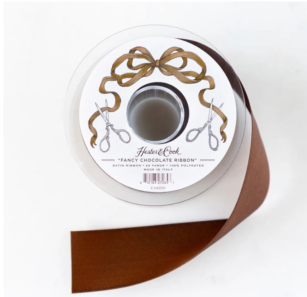 Partly unrolled spool of Fancy Chocolate Ribbon with a bow and scissors illustration on the label; available in multiple sizes.