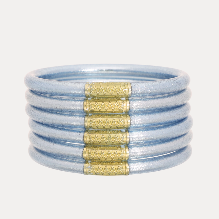 Set of six light blue Celeste All Weather Bangles® with textured gold bands, available in S, M, L, and XL sizes.