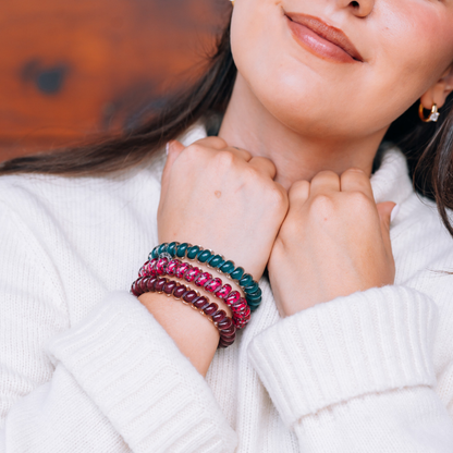 Three Harvest Hues Large Hair Ties in teal, pink, and purple shown on wrists. Available in large size.