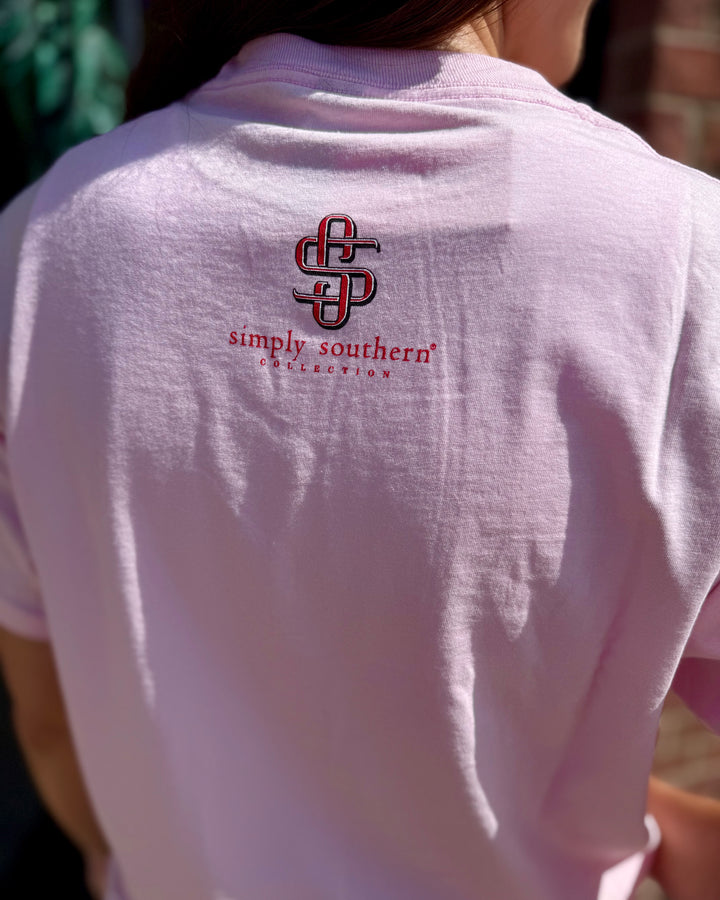 Light pink Y’all Are Nuts Tee with “Simply Southern Collection” logo and red and black text on the back, available in sizes S–XL.