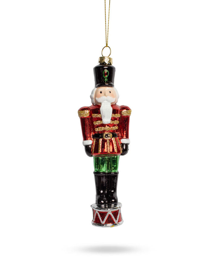Bradford Nutcracker ornament in red coat and black hat on a drum base.