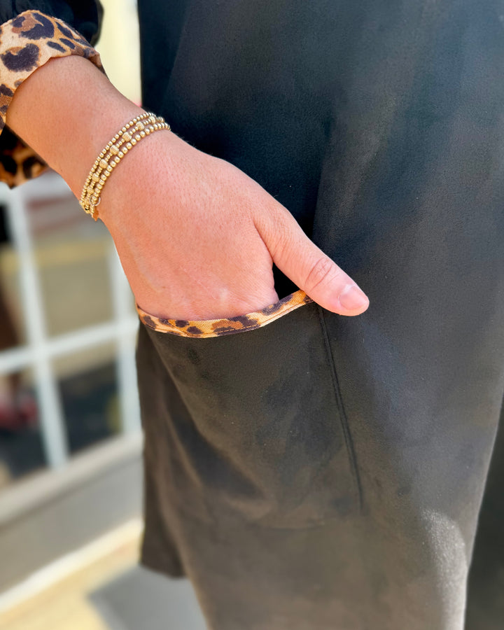 Leopard Contrast Dress: black faux suede, leopard print trim, 3/4 sleeves, pockets. Available in sizes XS–XL.