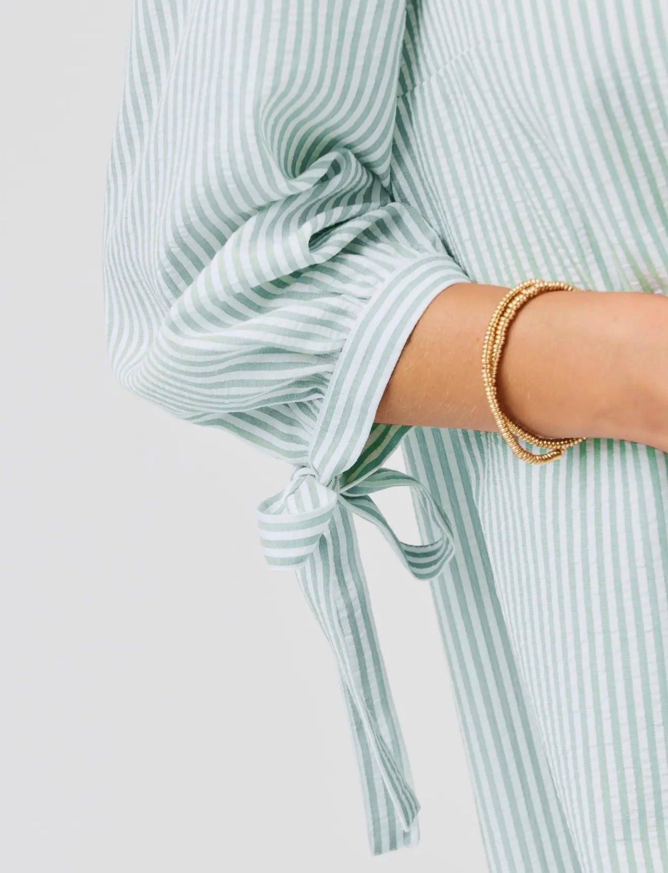 Laney Seafoam Dress with light green and white stripes, 3/4 sleeve bow. Available in sizes XS–XL.