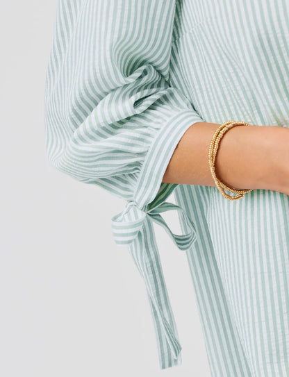Laney Seafoam Dress with light green and white stripes, 3/4 sleeve bow. Available in sizes XS–XL.