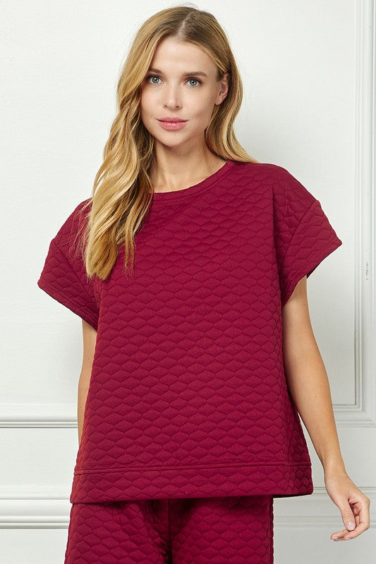 Honey Comb Textured Set: quilted dark red, short-sleeved top and matching bottoms. Available in sizes XS–XL.