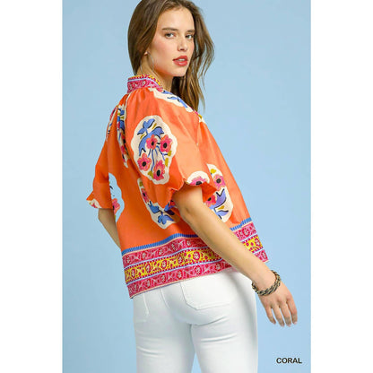 Sunset Floral Embroidery Top with colorful florals, wide sleeves, patterned hem. Available in XS-XL.