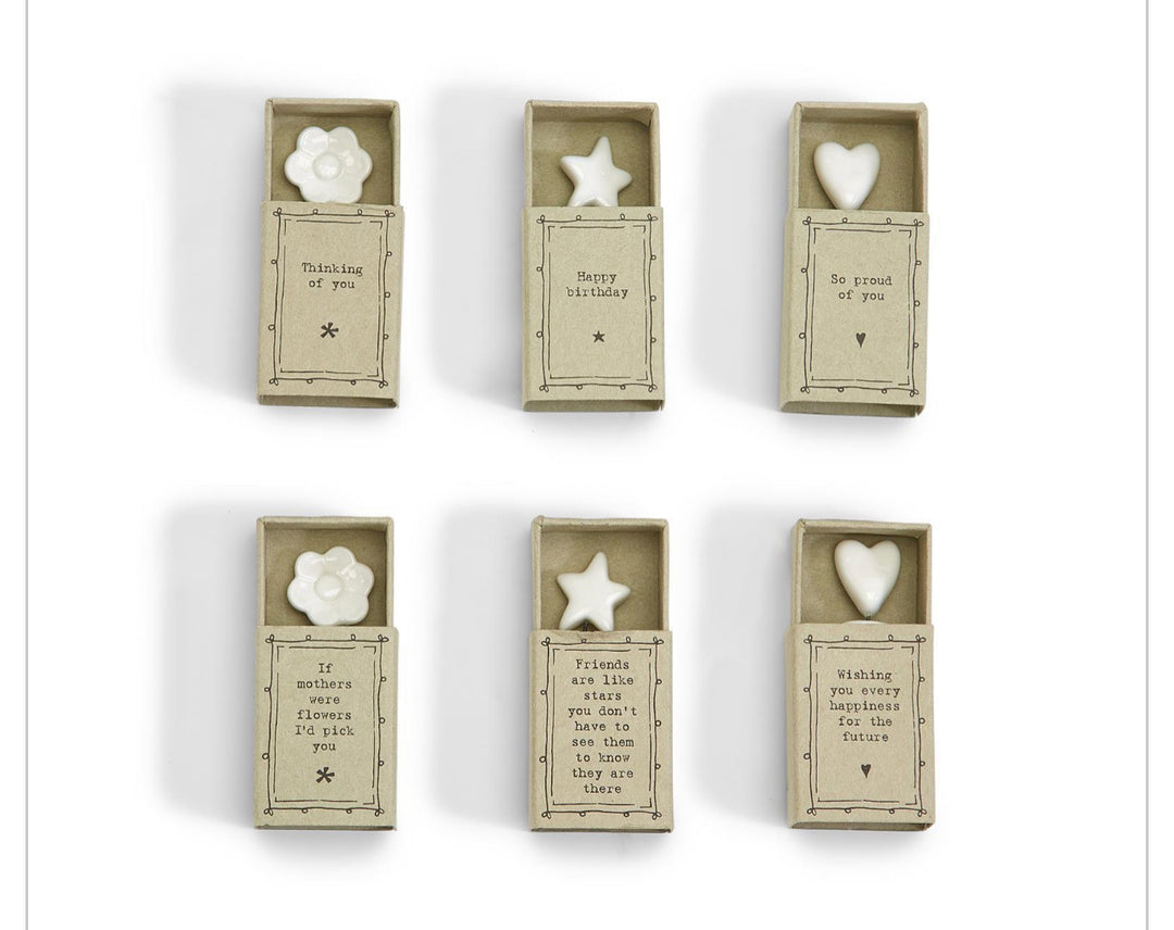 Six Sweet Wishes Matchbox UN boxes with white porcelain flower, star, or heart; includes note. Sizes vary.
