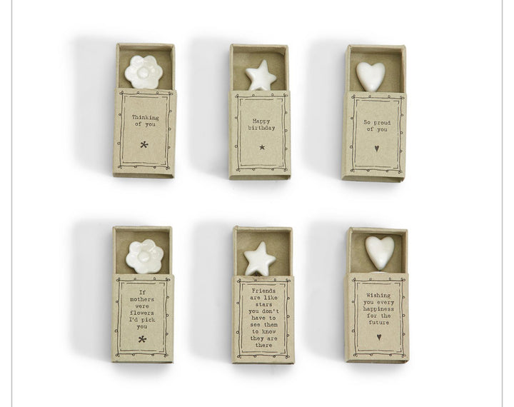 Six Sweet Wishes Matchbox UN boxes with white porcelain flower, star, or heart; includes note. Sizes vary.