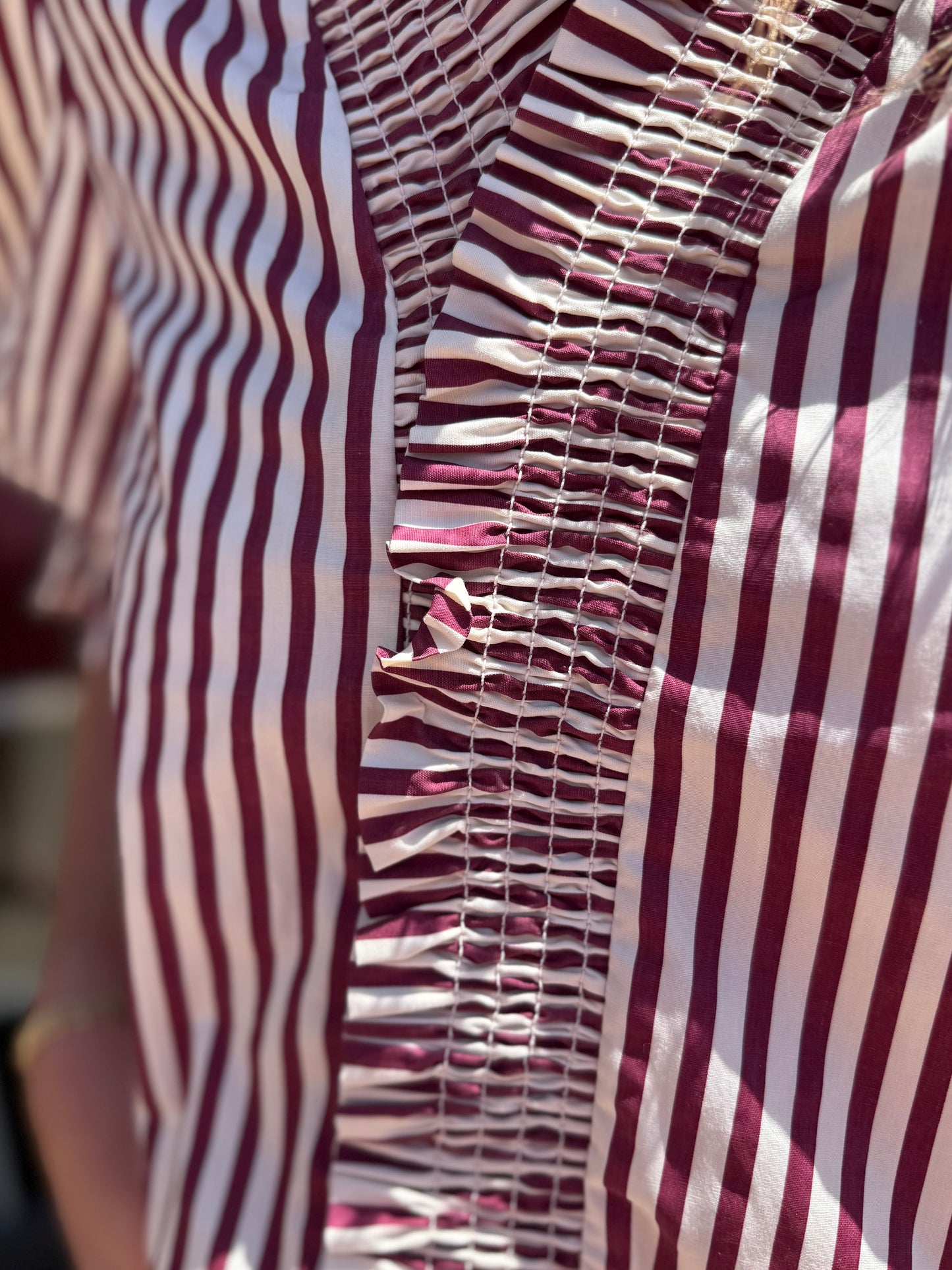 Maroon Striped Cinched Blouse with white vertical stripes, pleated and gathered center stitching, button-down design. Available in sizes XS–XL.