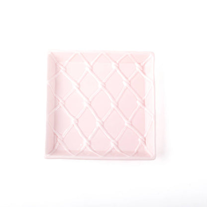 Square, light pink ceramic tray with a raised diamond pattern. Available sizes: beverage napkin tray.